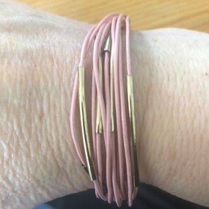 Pink strands with gold toned bars bracelet.